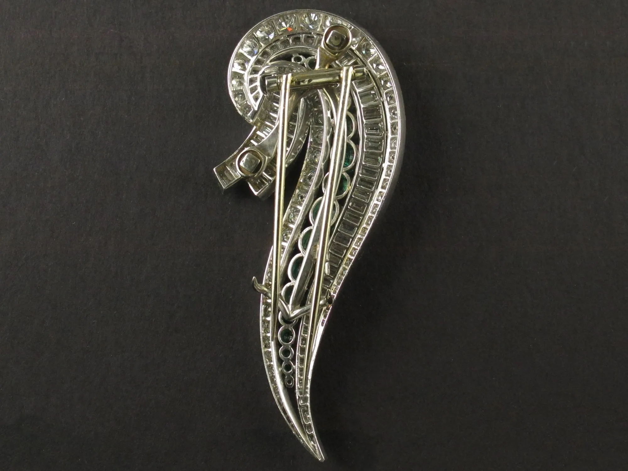 An Art Déco platinum, diamond and emerald brooch. 1935 circa